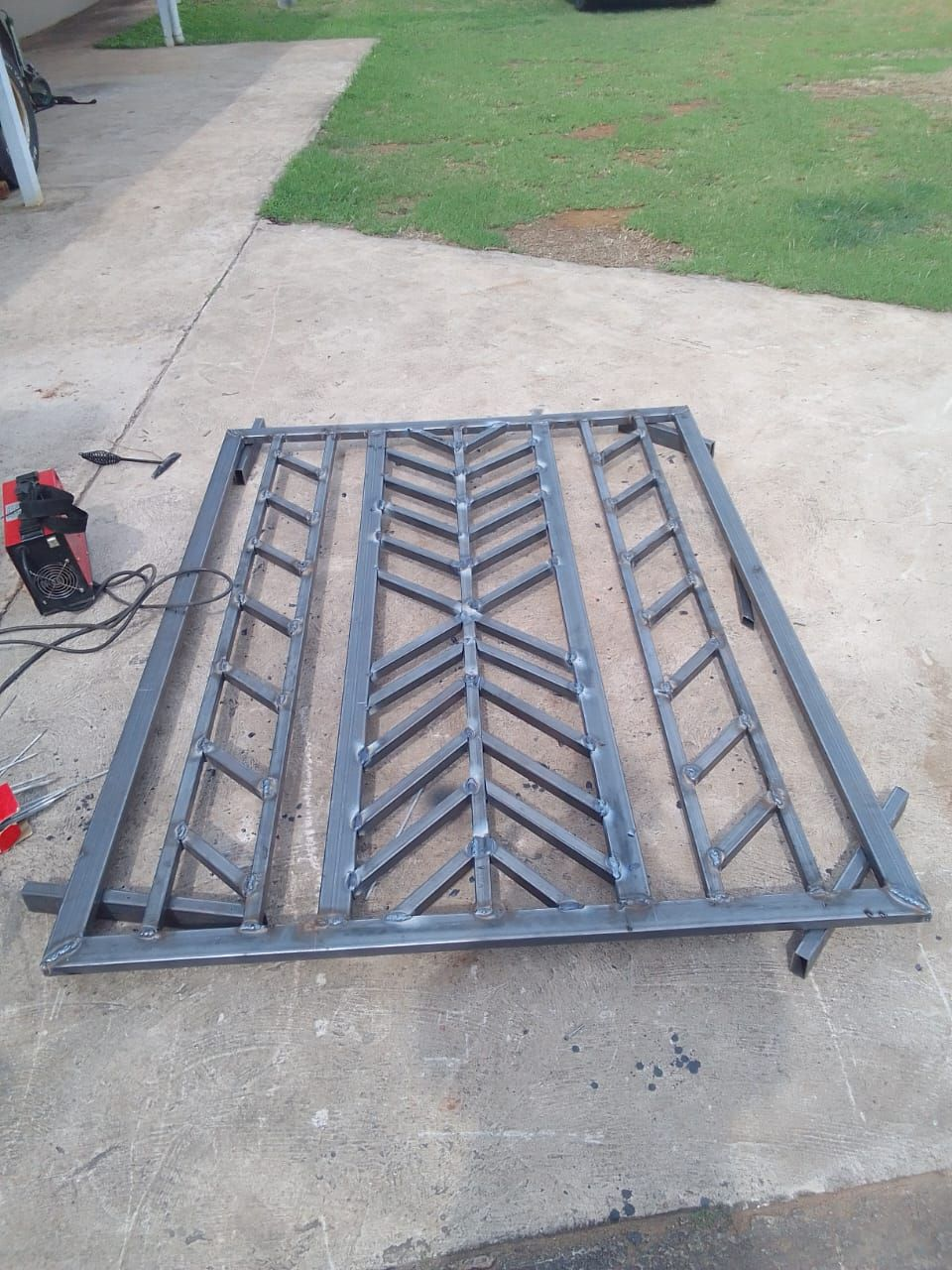 Hand-welded steel security gate with chevron detail